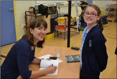 Children enjoying an author workshop with Emma Barnes